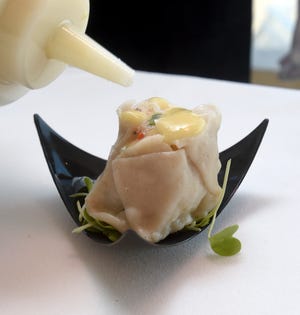 A lobster and shrimp mousse dumpling with black truffles and lemon vinaigrette looks a bit like a rose. It's one of the Pan Asian dumplings The Ocean House's executive chef Tom Woods normally has on the menu.